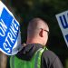 Striking autoworkers want to end a system that pays different wages for the same job