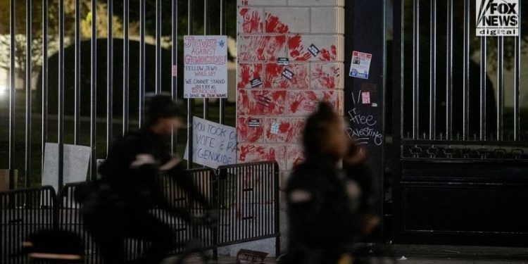 Pro-Palestinian protesters seen shaking White House gate vandalized with red paint: ‘F–k Joe Biden’